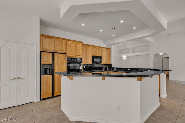 1532 Via Cassia, Henderson, NV 89052 - kitchen with black appliances, light tile patterned floors, a breakfast bar, a center island with sink, and recessed lighting