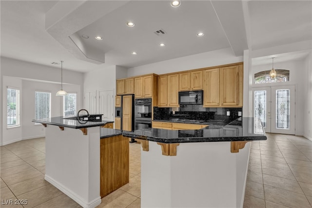 1532 Via Cassia, Henderson, NV 89052 - kitchen featuring black appliances, a breakfast bar, recessed lighting, light tile patterned floors, and decorative backsplash