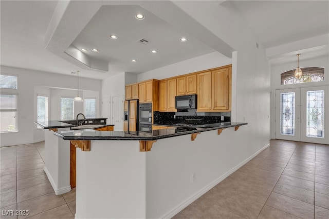 1532 Via Cassia, Henderson, NV 89052 - kitchen featuring black appliances, light tile patterned floors, a breakfast bar area, backsplash, and recessed lighting