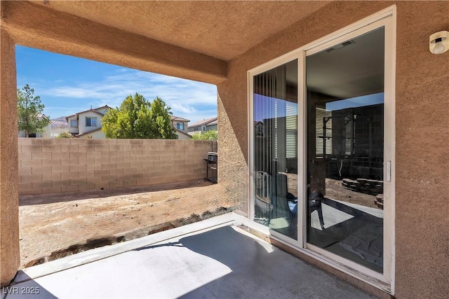 view of patio / terrace featuring fence