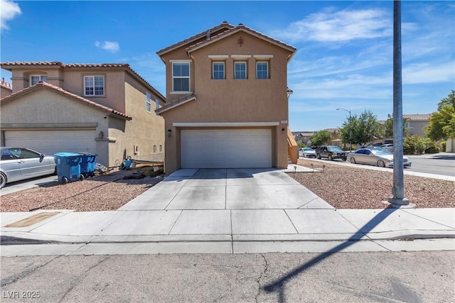 view of front of home featuring stucco siding, an attached garage, and driveway