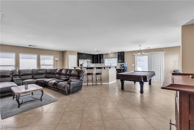 living area with plenty of natural light, billiards, and light tile patterned flooring