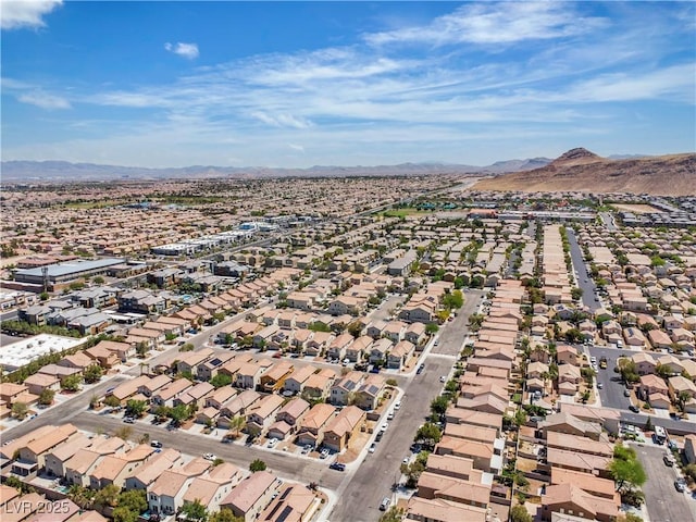 aerial overview of property's location featuring a mountainous background and nearby suburban area