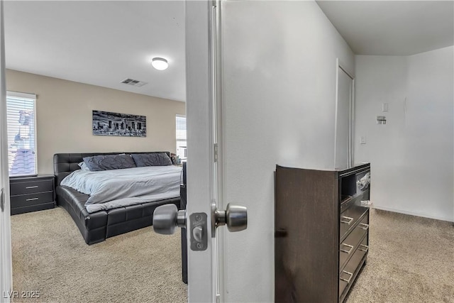 carpeted bedroom featuring multiple windows