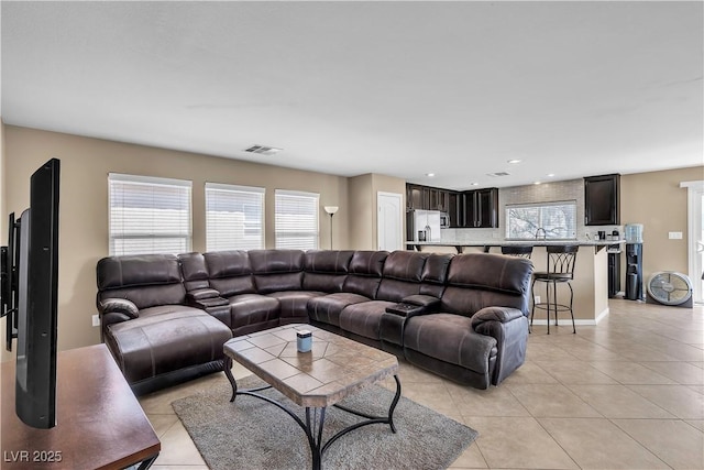 living room with light tile patterned flooring, healthy amount of natural light, and recessed lighting