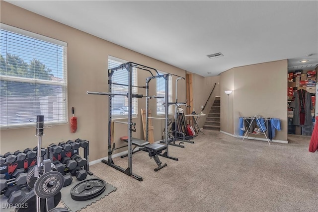 exercise room with carpet floors and baseboards