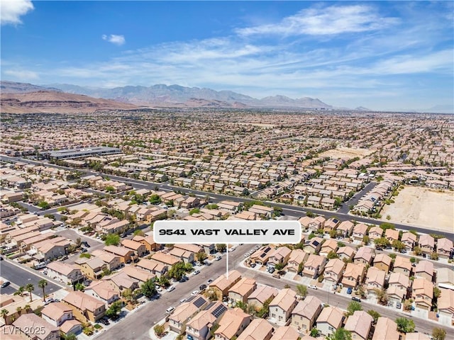 aerial view of property's location with nearby suburban area and mountains