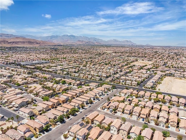 aerial view of property and surrounding area with a mountain backdrop and nearby suburban area