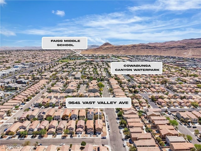 aerial view of property's location with mountains and nearby suburban area