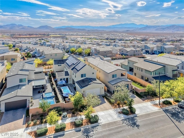 aerial view of residential area featuring mountains