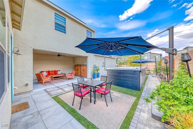 view of patio / terrace featuring a hot tub, outdoor lounge area, a fenced backyard, and outdoor dining area