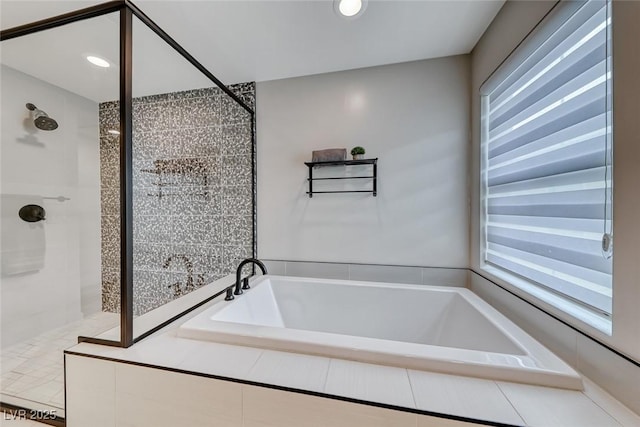 bathroom with a shower stall, a bath, and recessed lighting