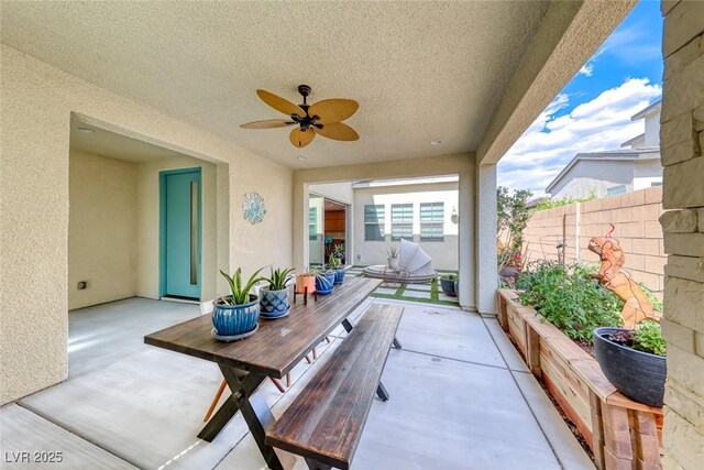 view of patio featuring fence and a ceiling fan
