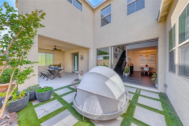 view of patio with outdoor dining area, a ceiling fan, and a wooden deck