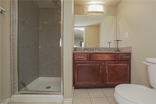 bathroom featuring toilet, tile patterned floors, a stall shower, and vanity