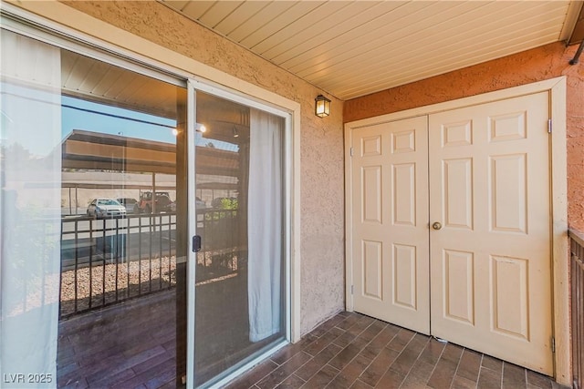doorway to property featuring stucco siding