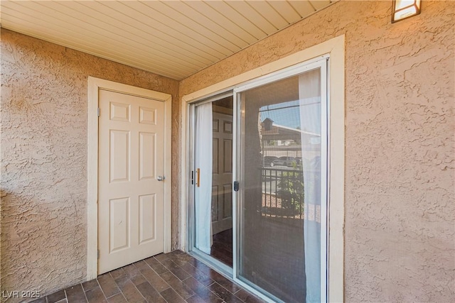 property entrance featuring stucco siding