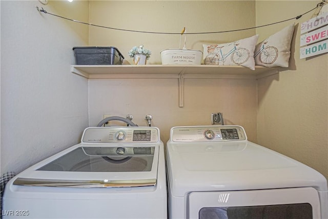 washroom with washing machine and dryer