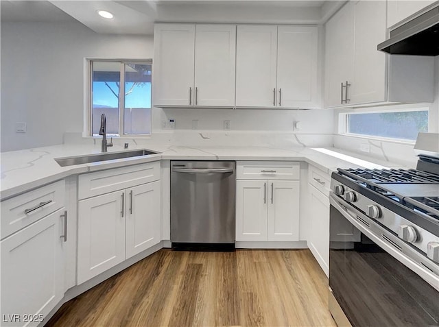 983 Plantain Lily Ave, Las Vegas, NV 89183 - kitchen featuring stainless steel appliances, a sink, under cabinet range hood, white cabinets, and recessed lighting