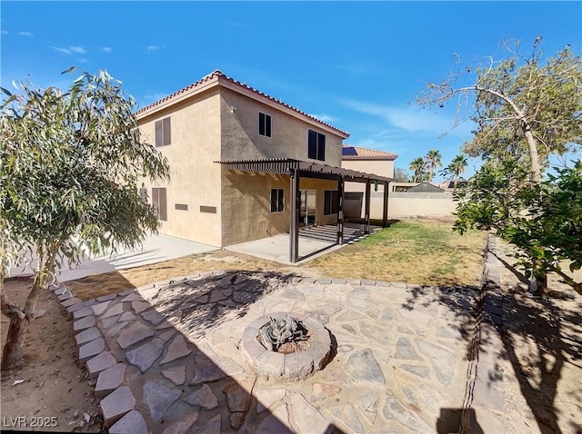 983 Plantain Lily Ave, Las Vegas, NV 89183 - rear view of property featuring stucco siding, a tile roof, a fire pit, a patio, and a pergola