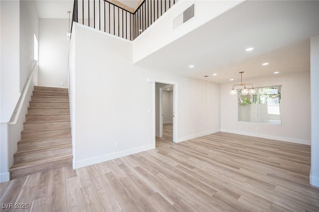 1620 Western Lily St, Las Vegas, NV 89128 - unfurnished living room featuring a chandelier, stairs, recessed lighting, light wood finished floors, and baseboards