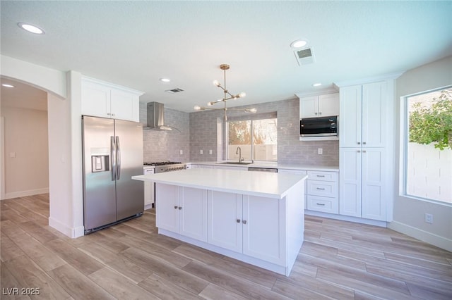 1620 Western Lily St, Las Vegas, NV 89128 - kitchen featuring appliances with stainless steel finishes, wall chimney exhaust hood, a sink, backsplash, and recessed lighting