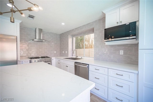 1620 Western Lily St, Las Vegas, NV 89128 - kitchen featuring wall chimney exhaust hood, appliances with stainless steel finishes, a sink, decorative backsplash, and white cabinetry