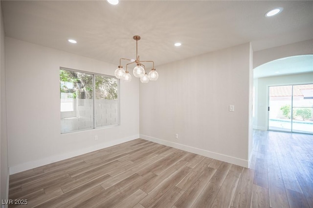 1620 Western Lily St, Las Vegas, NV 89128 - unfurnished room with arched walkways, healthy amount of natural light, wood finished floors, recessed lighting, and baseboards