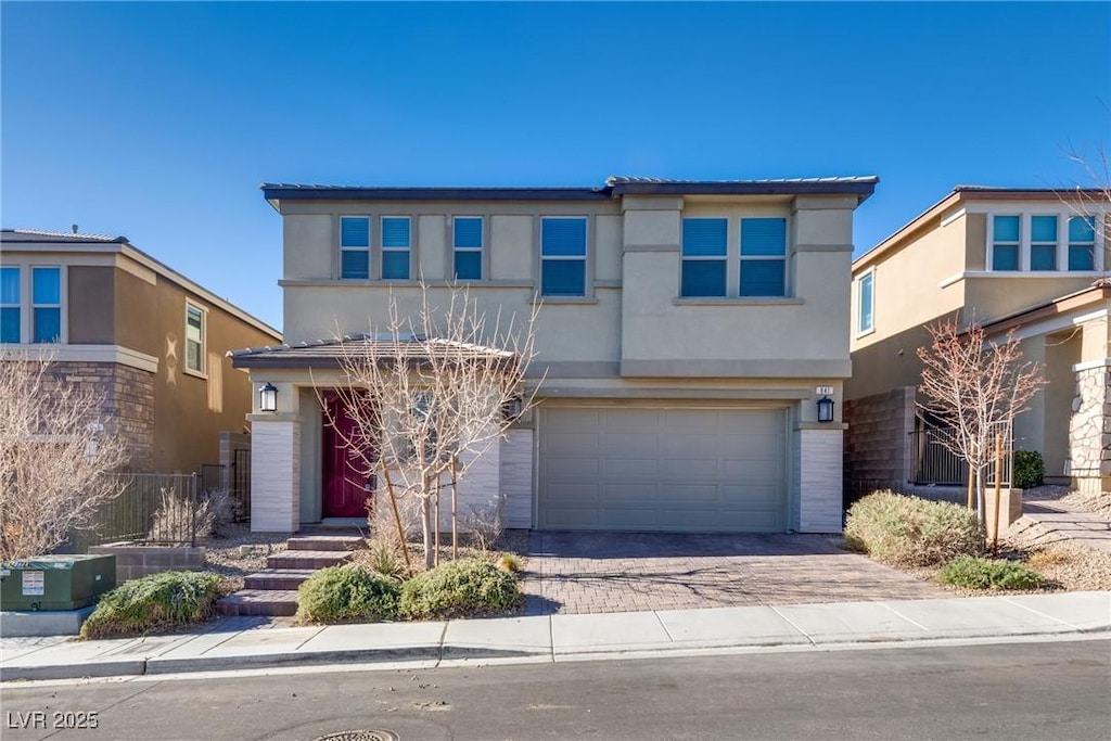 841 Riverlawn Pl, Las Vegas, NV 89138 - view of front of home featuring stucco siding, a garage, and driveway