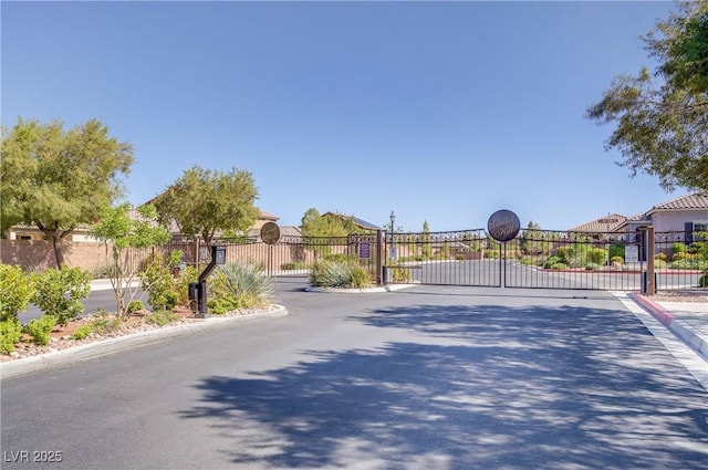 748 Dellenbaugh Ct, Las Vegas, NV 89178 - view of asphalt street featuring a gate, curbs, and a gated entry