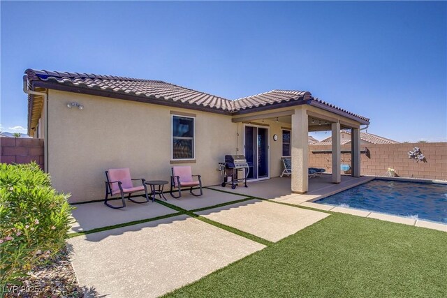 748 Dellenbaugh Ct, Las Vegas, NV 89178 - back of property with a patio area, a fenced backyard, stucco siding, and a tile roof