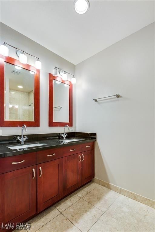 4575 Dean Martin Dr Unit 2701, Las Vegas, NV 89103 - bathroom with baseboards, double vanity, and tile patterned flooring