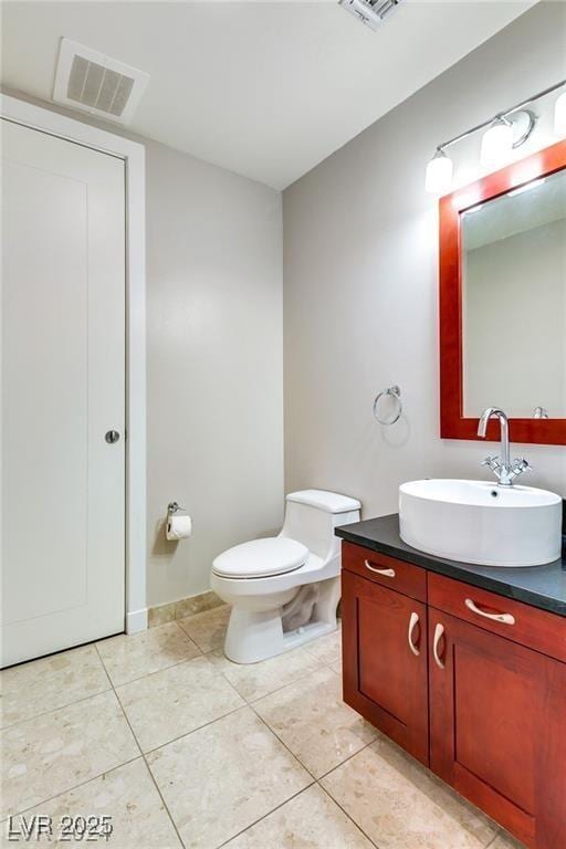 4575 Dean Martin Dr Unit 2701, Las Vegas, NV 89103 - bathroom featuring vanity, toilet, and tile patterned flooring