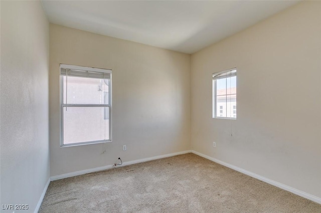 carpeted spare room with baseboards