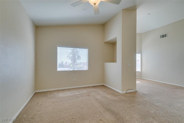 carpeted empty room featuring a ceiling fan, baseboards, and high vaulted ceiling
