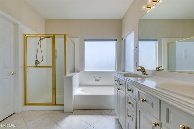 bathroom with a shower stall, double vanity, a bath, and tile patterned floors