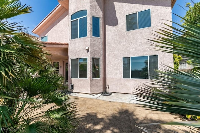 back of house with stucco siding