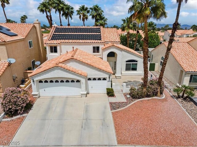 2024 Spruce Brook Dr, Henderson, NV 89074 - mediterranean / spanish-style house featuring a tiled roof, an attached garage, concrete driveway, fence, and a gate