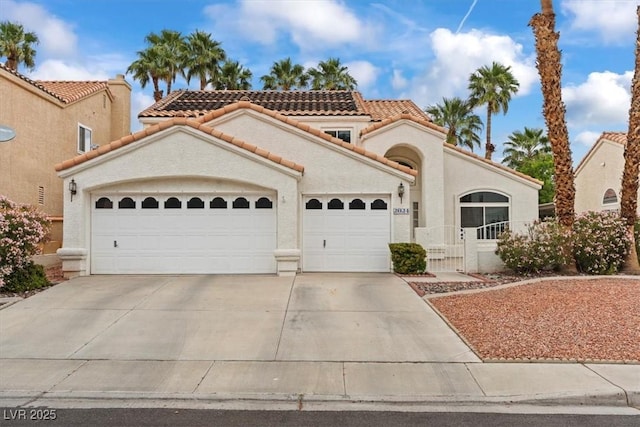 2024 Spruce Brook Dr, Henderson, NV 89074 - mediterranean / spanish home featuring a garage, a tiled roof, concrete driveway, stucco siding, and a gate