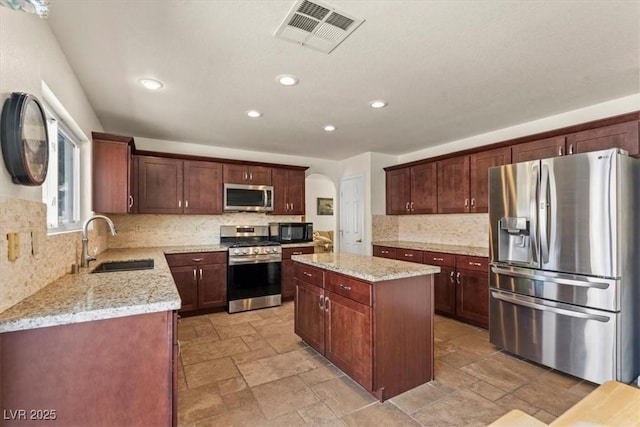 2024 Spruce Brook Dr, Henderson, NV 89074 - kitchen with stainless steel appliances, a sink, a center island, recessed lighting, and tasteful backsplash