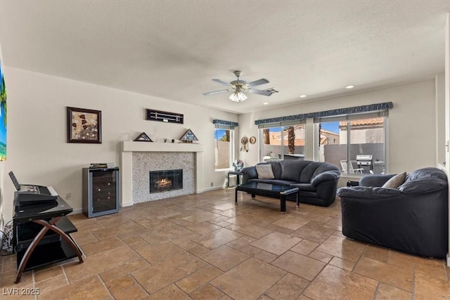 2024 Spruce Brook Dr, Henderson, NV 89074 - living area with beverage cooler, ceiling fan, stone tile floors, a glass covered fireplace, and recessed lighting