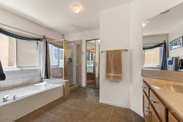 2024 Spruce Brook Dr, Henderson, NV 89074 - bathroom featuring a shower stall, vanity, a bath, tile patterned floors, and baseboards