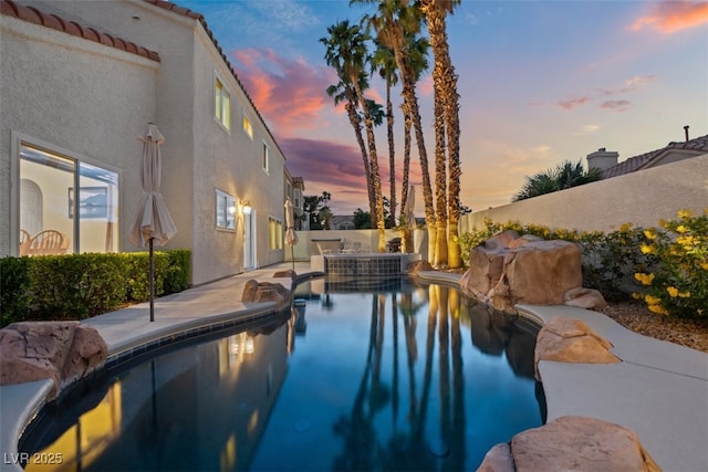 2024 Spruce Brook Dr, Henderson, NV 89074 - pool at dusk with a patio area, a fenced backyard, and a pool with connected hot tub
