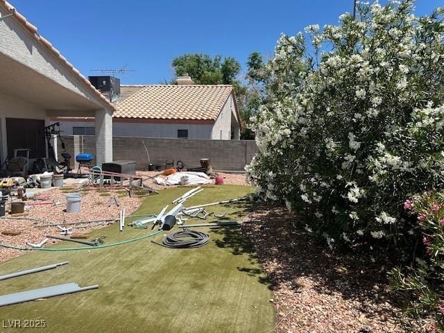 view of yard featuring fence and cooling unit