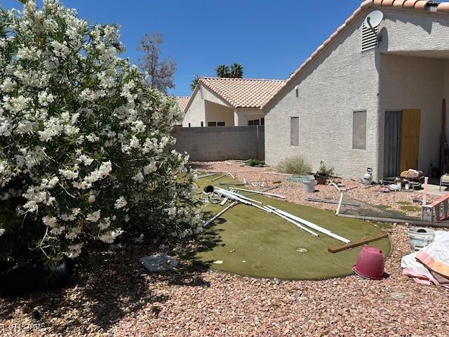 view of yard with a putting green and fence