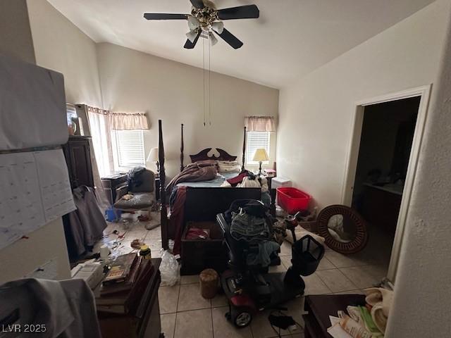 bedroom with lofted ceiling, tile patterned floors, and ceiling fan