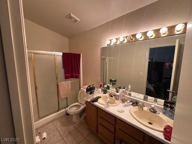 full bath with tile patterned flooring, a stall shower, double vanity, toilet, and vaulted ceiling