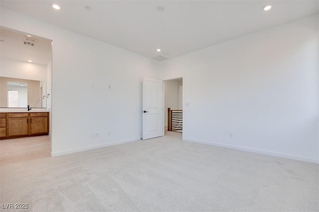 11946 Glide Reflection Ave, Las Vegas, NV 89138 - unfurnished bedroom featuring light carpet, baseboards, recessed lighting, ensuite bath, and a sink
