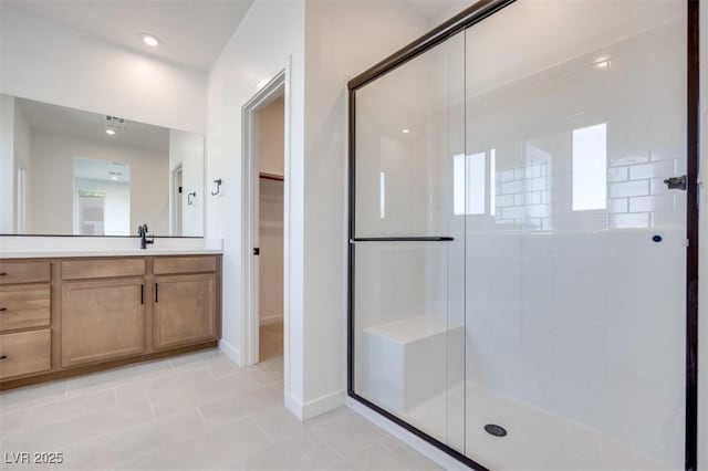 11946 Glide Reflection Ave, Las Vegas, NV 89138 - bathroom with a shower stall, tile patterned floors, vanity, a walk in closet, and baseboards