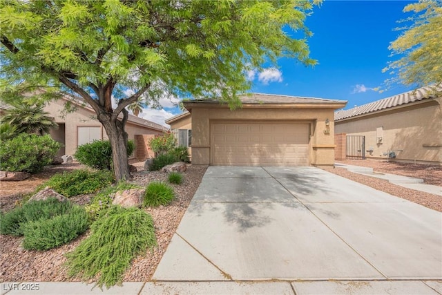 view of front of property featuring concrete driveway, stucco siding, and an attached garage